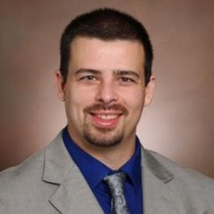 man in suit and tie smiling for camera